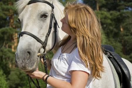 Beautiful view of a woman and a horse, close viewの写真素材