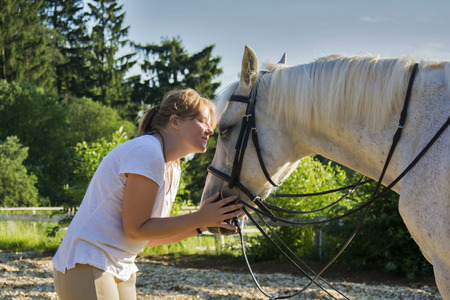Beautiful view of a woman and a horse, close viewの写真素材