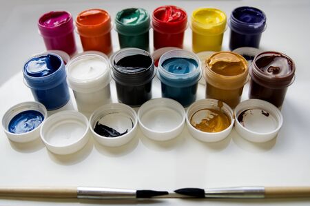 Beautiful view of paints and wooden brushesの写真素材