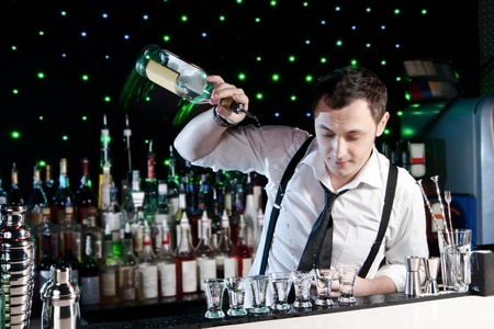 Bartender bartender is pouring a drinkの写真素材
