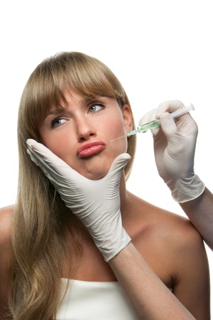 Atractive blond woman making a funny face in time of injectionの写真素材