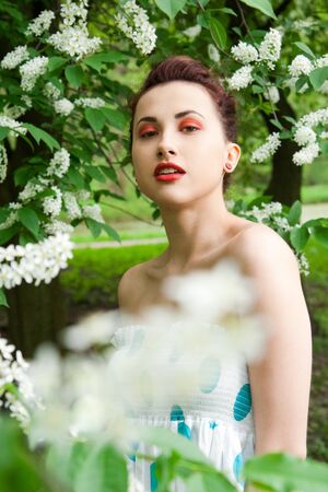 portrait of young brunette in the spring parkの写真素材