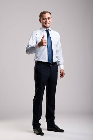 Young and successful businessman showing thumbs upの写真素材