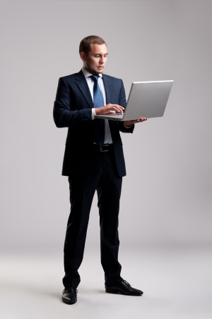 Young and successful businessman typing on his laptopの写真素材