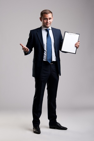 Young and successful businessman holding a clipboardの写真素材