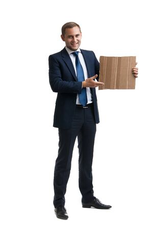Young and successful businessman is holding a cardboardの写真素材