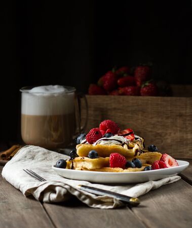 Waffles with berries on a plateの写真素材