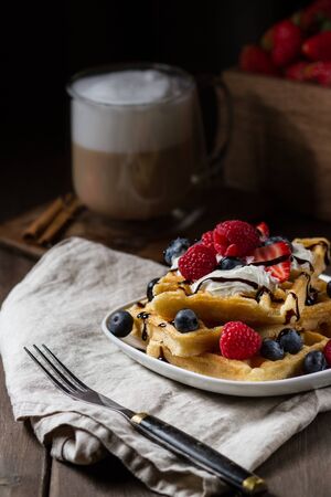 Waffles with berries on a plateの写真素材