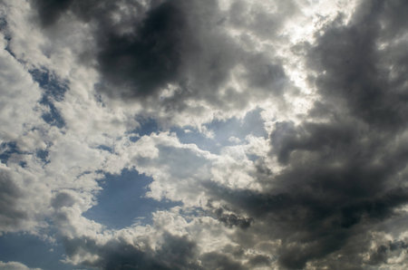 Dark clouds break the sunlight gradually covers the blue sky.