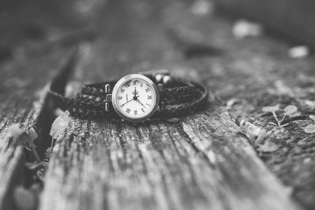 black and white watch on wooden background