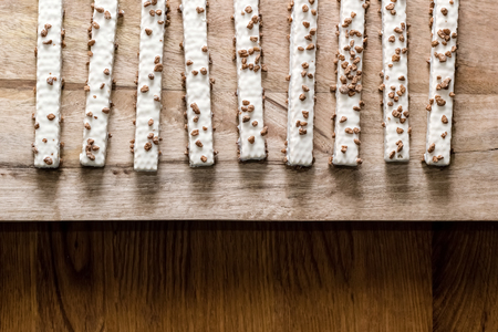 cookie wafers in glaze on a wooden table, top viewの写真素材