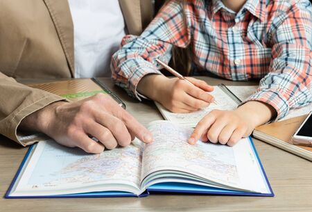 Homeschooling. Father helps daughter with her homework.
Learning concept. Communication concept.の写真素材