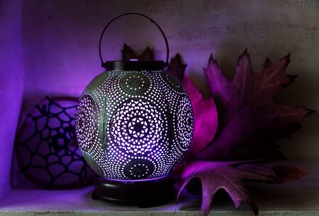 Aroma diffuser in the style of an ancient oriental lamp. Still life with a diffuser, a catcher of dreams and maple leaves.の写真素材