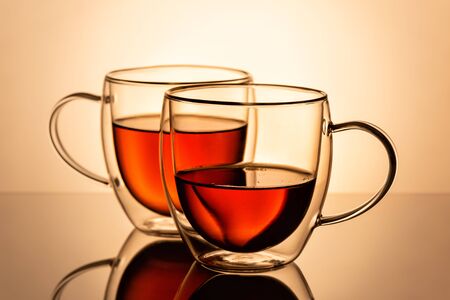 Two double wall glass cups with tea.の写真素材