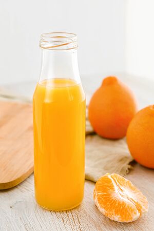 Tangerine juice in a bottle and slices tangerines.の写真素材