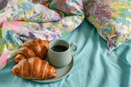 Breakfast in bed. Morning coffee and two croissants.の写真素材