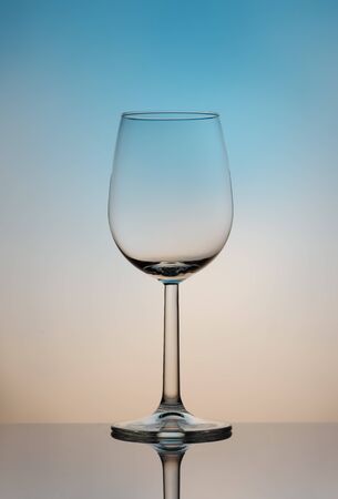 Still life. Glass to clear. Wine glass on a high and thin stalk on a colored background.の写真素材