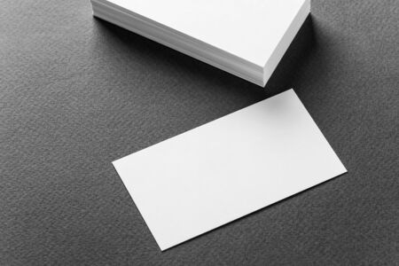 Stack of business cards on a grey background.の写真素材