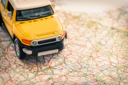 The SUV model is on the road map. Travel concept.の写真素材