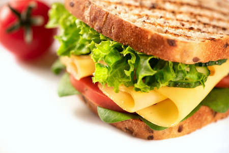Sandwich with cheese and vegetables on a white background. High key.の写真素材