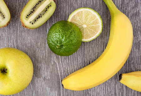 Fresh fruits. Different fruits on a wood. Food background. Top view.の写真素材