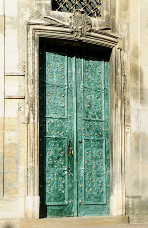 Ancient green door with gilded ornaments.の写真素材