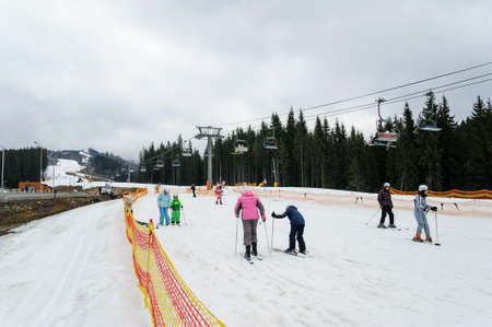 Ski Resort Bukovel. Carpathians. Ukraine- 03.10.2017. Area for teaching beginners. Adults and children are learning to ski.のeditorial素材