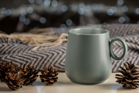 Holidays composition. Cup with hot drink, cones, plaid.の写真素材