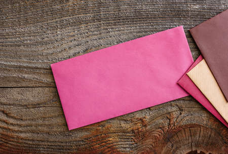 Multicolored envelopes on a wooden background. Communication concept.の写真素材