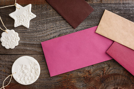 Multicolored envelopes and Christmas decor on a wooden background. The concept of communication.