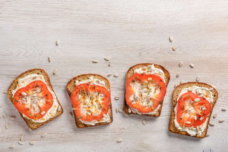 Toasts with cream cheese, pepper, microgreens and sunflower seedsの写真素材