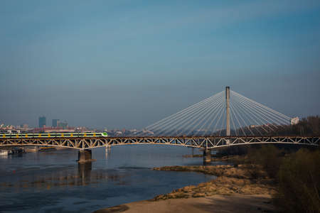 Warsaw. Poland. 03.30.2022. The train travels across the bridge over the Vistula.のeditorial素材