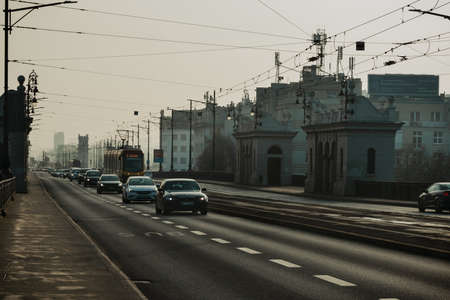 Warsaw. Poland. 03.30.2022. Car traffic. Trams run through the middle of the highway.のeditorial素材
