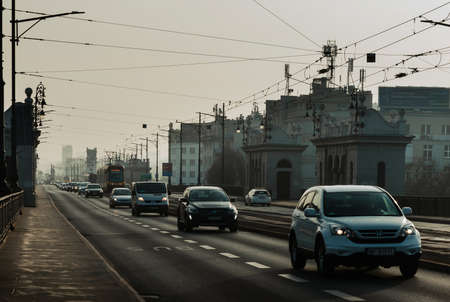 Warsaw. Poland. 03.30.2022. Car traffic. Trams run through the middle of the highway.のeditorial素材