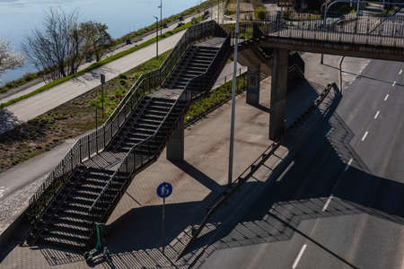 Warsaw, Poland- 04.18.2022: Pedestrian bridge with stairs over the highway.のeditorial素材