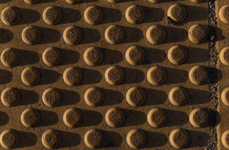 Grooved tiles anti-slip strips of footpath. Cones truncated background texture.の写真素材