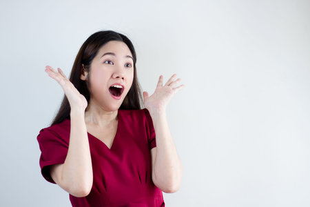 Asian women wear red shirt are Surprised and shocked with space for your promotion advertisement and...