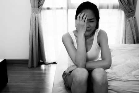 Asian woman who is depressed  is crying with using hand  touch her face. Broken heart and depression. Healthy life and mental concept.の写真素材