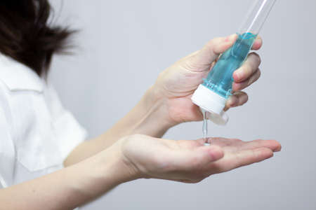 Woman's hand are cleaning and washing hand by pouring alcohol gel to protect from virus and COVID19の写真素材