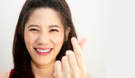 Asian beautiful woman make mini heart gesturing  and express happiness and smiling for valentine's day. Love conceptの写真素材