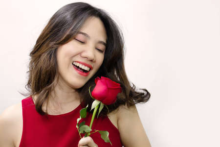 Asian Beautiful woman w are happy receiving red rose on a valentine's day with smiling.の写真素材