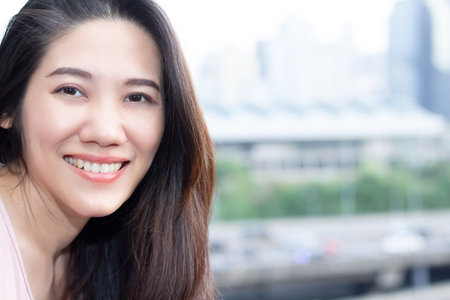 Asian beautiful woman looking to camera with smile and a happiness on her leisure day