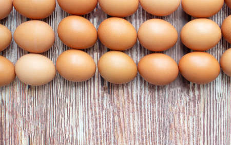 Eggs are arranged for three row on a tableの写真素材