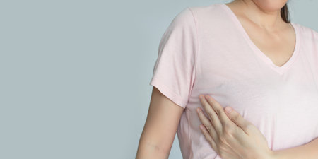 Asian woman is raise hand touch her breast to check cancer  to encourage breast cancer patient and...