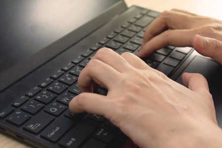 Woman hands  who use laptop typing keyboard Concept and an online technology usageの写真素材