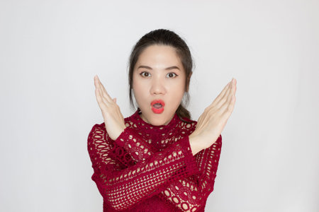 Asian Beautiful woman are raise hand and crossing to make forbidden and stop symbol with  a serious face.の写真素材