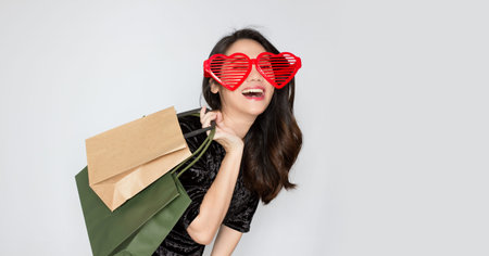Asian beautiful woman  hold carry packs and wearing bid  glasses with happiness and laugh and a...