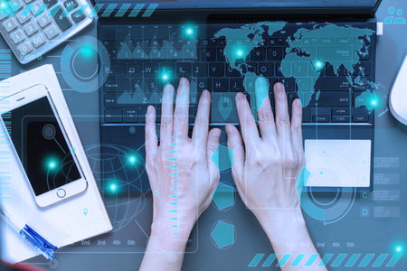 Flat lay of woman hand is working with typing laptop, smartphone, note book, calculator and pen and...