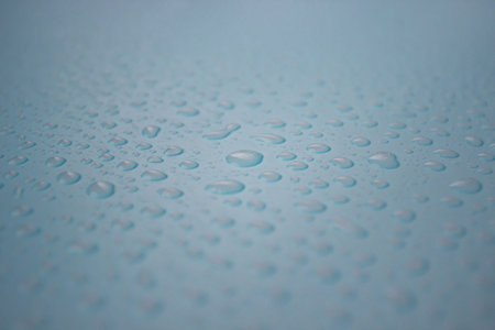 Close up of dropped water on blue background. Freshness, raindrop