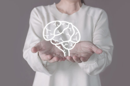 Woman hand holds illustrator of brain. A Mental health protection and care.の写真素材